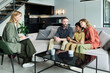 © pressmaster - Family sitting on couch discussing important matters with counselor in modern living room Focused on understanding each other and resolving life challenges