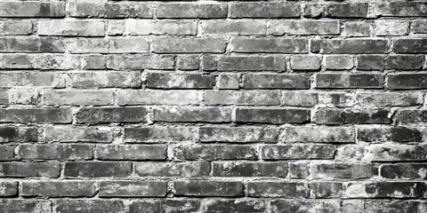 Poster - Desaturated brick wall background featuring clean black and white brickwork. This brick wall texture offers a grunge vintage aesthetic with ample copy space for creative purposes.