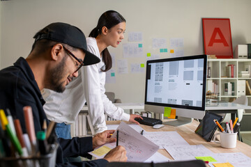 Wall Mural - ux ui designers discussing and brainstorming on wireframes for a website and mobile app prototype, i