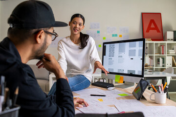 Wall Mural - ux ui designers discussing and brainstorming on wireframes for a website and mobile app prototype, i