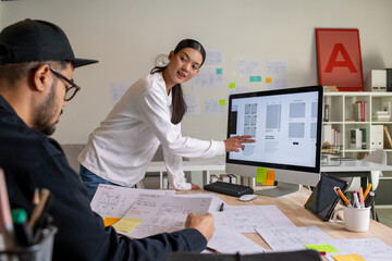 Wall Mural - ux ui designers discussing and brainstorming on wireframes for a website and mobile app prototype, i