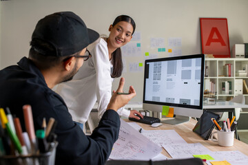 Wall Mural - ux ui designers discussing and brainstorming on wireframes for a website and mobile app prototype, i