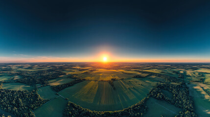 Wall Mural - vibrant sunrise over expansive green fields and wooded areas in early morning light