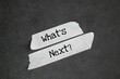 © Fauzi - white sticker with the word question What's Next? next step concept