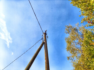 Wall Mural - Old pole with wires against the sky. Electric transmission line. Eco-friendly energy