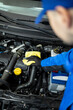 © zphoto83 - Mechanic cleaning engine components in an automotive service center during daytime