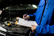 © zphoto83 - Mechanic conducts vehicle inspection and documentation in a service garage during the day