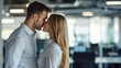 © standret - Romantic couple kissing in office environment with tender affection