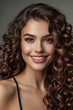 © Nia™ - Beautiful smiling brunette model girl with long curly hair . Smiling woman hairstyle wavy curls . Fashion , beauty and makeup portrait