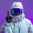 © sakuratanaka - A person in a white ski suit and goggles points their index finger upwards.