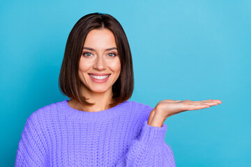 Wall Mural - portrait of attractive cheerful girl demonstrating holding on palm copy space ad new novelty isolate