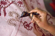 © robertharding - Woman using a pen-like tool (canting) to apply liquid hot wax to create pattern on the fabric before dyeing, workshop of Kidang Mas Batik House, Lasem, Java island, Indonesia, Southeast Asia