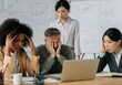 © Running opossum - Stressed diverse team analyzing data in office meeting