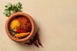 © Faizal - Colorful Spices and Herbs in Clay Bowl on Neutral Background