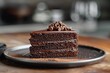 © KanitChurem - Delicious chocolate cake slice on a plate.