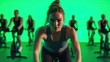 © Thanaporn - A spin class instructor leading a high-energy cycling session, with a green screen background for vibrant visuals