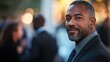© KEOCHAN - A candid professional portrait of a man networking at an event, capturing an engaging and approachable demeanor