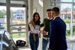 © DusanJelicic - Young couple is visiting a car dealership, interacting with a salesman.