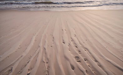 Fototapete - Beach with sand and water. The sand is very fine and the water is calm. There are no people or animals visible in the image
