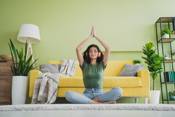 Wall Mural - Full length portrait of nice young girl meditate pray floor green interior living room flat indoors