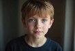 © Julija - A young boy from Russia gazes directly at the viewer with captivating grey eyes. His tousled hair frames his face, and he wears a cozy casual clothes. Rosy cheeks, piercing serious look. Generative AI