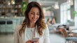 © Pat J. - Businesswoman in a bright office, Hispanic, engaging with her smartphone, dressed formally