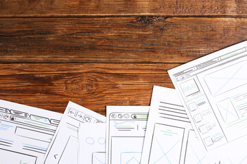 Wall Mural - developing ui design. sketches of website wireframes on wooden table, top view