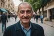 © ThomasLENNE - Close portrait of a smiling senior Syrian man looking at the camera, Syrian city outdoors  blurred background