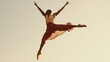 © musa - Male dancer leaping gracefully in the air, arms outstretched.