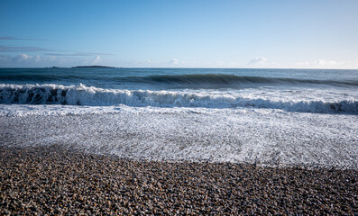 Wall Mural - Picturesque beach with small waves sea foam new zealand west coast