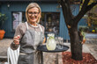 © Miljan Živković - Smile woman waitress serving lemonade at restaurant garden