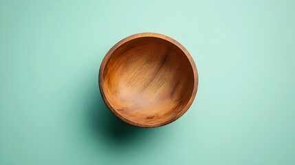 Wall Mural - A wooden bowl is sitting on a green wall