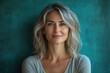 © julija - charismatic middle-aged woman with a genuine smile poses confidently against a vibrant turquoise background, capturing natural light that enhances her features and personality