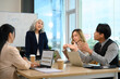 © Prathankarnpap - Mature executives businesswoman explaining a strategy on whiteboard during meeting