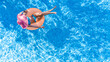 © Iuliia Sokolovska - Beautiful woman in hat in swimming pool aerial drone view from above, young girl in bikini relaxes and swims on inflatable ring donut and has fun in water on tropical vacation on holiday resort