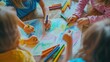 © Soklin - Children drawing with crayons or markers, focusing on creating colorful artwork