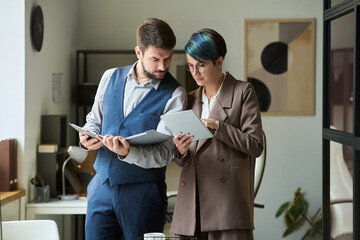 Poster - Confident female broker with tablet making presentation of financial fluctuations to male colleague with paper documents