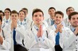 © vefimov - Group of doctors are clapping and smiling at a presentation. Scene is positive and celebratory