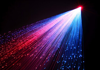 Wall Mural - A vibrant light beam with multiple colors of red, blue, and purple against a black background.