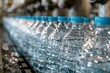 © dony - Bottled Water Production Line: A Close-Up View of Crystal-Clear Plastic Bottles on a Conveyor Belt in a Modern Factory Setting