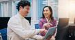© peopleimages.com - Collaboration, pointing and tablet with business people in office for creative, design or web development. Feedback, laughing or funny with Japanese man and woman in workplace for discussion