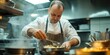 © Lubos Chlubny - Professional chef preparing food in restaurant kitchen
