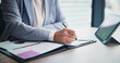 © peopleimages.com - Business person, hands and writing with tablet for analytics, planning or corporate statistics at office. Japan, financial analyst and technology with documents or paperwork for performance review