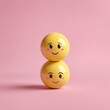 © Dmitriy K. - Two yellow emoticon spheres stacked on a pink background