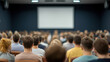 © Jakrapan - Engaged audience in lecture hall with presentation screen visible
