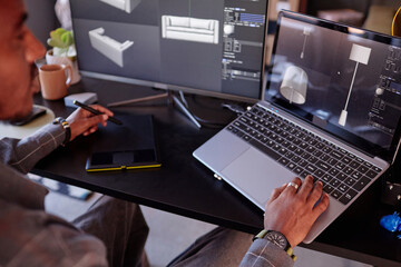 Leinwandbilder - Designer is focusing on creating detailed interior models on laptop while using graphic tablet and multitasking in modern creative studio