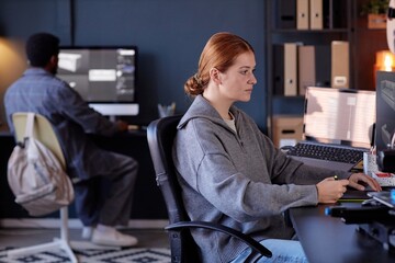 Fototapete - Two professionals working in modern office environment, focusing on computer screens, completing tasks efficiently, and maintaining a professional atmosphere in a well-lit space