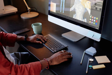 Fototapete - Designer working on intricate 3D models displayed on computer screen in modern office space. Various tools and gadgets are scattered on desk, hinting at creative process