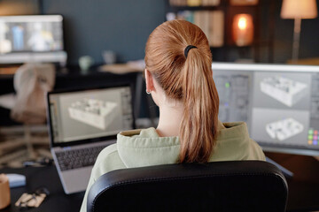 Fototapete - Person viewing computer screen with 3D modeling software, sitting at desk with another computer in workspace environment
