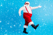 © deagreez - Full size profile side photo of funky santa claus go copyspace x-mas christmas holly newyear wear suspenders overalls sunglass boots cap isolated over blue color background